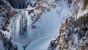 Yellowstone waterfall in winter still crashing through the ice
